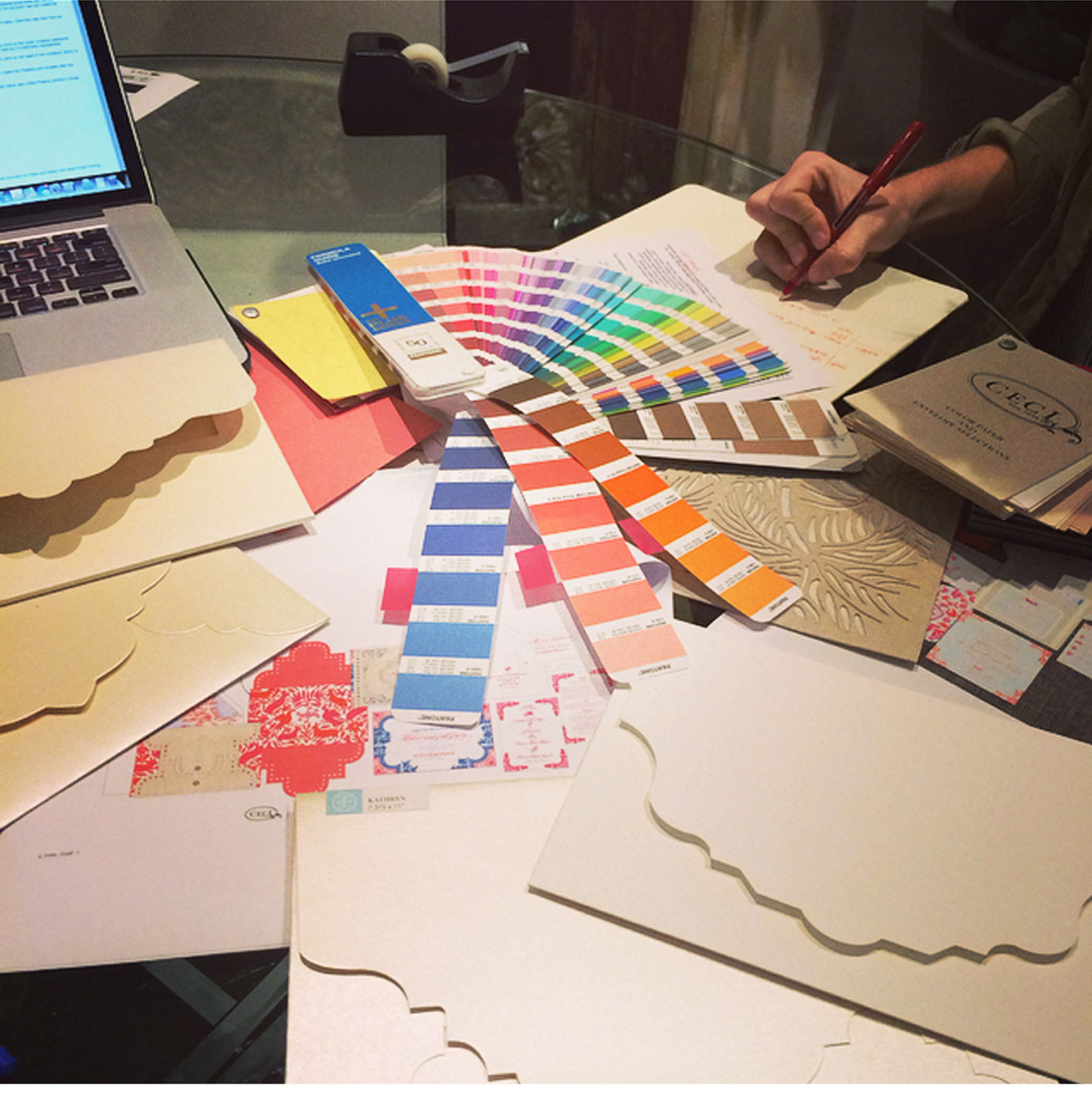 A Day in the Life of Ceci Johnson - 3:30 PM Design meeting. I sit down with my team to flesh out all the possibilities including Pantone colors, style and envelopes to make sure our client sees the best options.